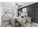 Stylishly decorated bedroom with a dark accent wall, ceiling fan, and coordinated furniture at 33263 Sycamore Leaf Dr, Wesley Chapel, FL 33545