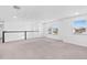 Bright bonus room with a staircase, neutral colors, and many large windows at 33263 Sycamore Leaf Dr, Wesley Chapel, FL 33545