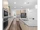 Well-equipped kitchen featuring stainless steel appliances, granite counters, and wood flooring at 33263 Sycamore Leaf Dr, Wesley Chapel, FL 33545