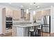 Modern kitchen featuring stainless steel appliances, granite countertops, and a spacious island with seating at 33263 Sycamore Leaf Dr, Wesley Chapel, FL 33545