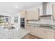 Bright kitchen boasts a stainless steel sink, modern appliances, and views to the dining area at 33263 Sycamore Leaf Dr, Wesley Chapel, FL 33545