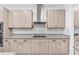 Kitchen showcasing granite countertops, stainless steel range hood, and sleek cabinets at 33263 Sycamore Leaf Dr, Wesley Chapel, FL 33545