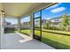 Screened-in patio showcasing backyard views and a concrete floor at 33263 Sycamore Leaf Dr, Wesley Chapel, FL 33545