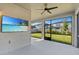 Enjoy the screened lanai with ceiling fan and flat screen TV overlooking the green backyard at 33263 Sycamore Leaf Dr, Wesley Chapel, FL 33545