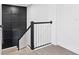 Carpeted staircase with stylish black and white banister at 33263 Sycamore Leaf Dr, Wesley Chapel, FL 33545