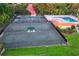 Aerial view of tennis courts and pool with surrounding landscape at Lake Jovita Golf & Country Club at 34516 Heavenly Ln, Dade City, FL 33525