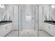 Bathroom with a glass shower enclosure, stylish tiling, and dual vanities with white cabinets at 34516 Heavenly Ln, Dade City, FL 33525
