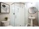 Bathroom featuring a glass shower, pedestal sink, and modern fixtures at 34516 Heavenly Ln, Dade City, FL 33525