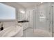 A luxurious bathroom features a soaking tub, glass shower, and white marble accents at 34516 Heavenly Ln, Dade City, FL 33525