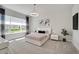 This is a bright bedroom with a modern style, light gray walls, and stylish decor at 34516 Heavenly Ln, Dade City, FL 33525