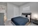 This bedroom features neutral colors, a plush grey bed and carpet, and modern décor at 34516 Heavenly Ln, Dade City, FL 33525