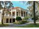 Grand clubhouse exterior featuring a classic architectural style with stately columns, manicured landscaping, and elegant accents at 34516 Heavenly Ln, Dade City, FL 33525