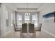 Elegant dining room with a modern chandelier, a glass-top table, and many windows at 34516 Heavenly Ln, Dade City, FL 33525