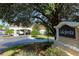 Welcoming entrance to Lake Jovita Golf & Country Club, featuring a covered drop-off area and lush landscaping at 34516 Heavenly Ln, Dade City, FL 33525