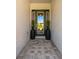 Inviting front entrance with a glass door, stone pavers, and potted plants at 34516 Heavenly Ln, Dade City, FL 33525