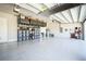 Spacious garage with ample storage, shelving units, and epoxy flooring at 34516 Heavenly Ln, Dade City, FL 33525