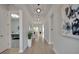 Bright hallway with hardwood floors, recessed lighting, and modern artwork at 34516 Heavenly Ln, Dade City, FL 33525