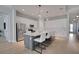 Modern kitchen featuring an island with seating, pendant lighting, and stainless steel appliances at 34516 Heavenly Ln, Dade City, FL 33525