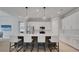 Kitchen with stainless steel appliances, white cabinets, an island with chairs, and modern pendant lights at 34516 Heavenly Ln, Dade City, FL 33525