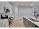 Bright kitchen boasts white cabinets, stainless appliances, quartz countertops, and tile backsplash at 34516 Heavenly Ln, Dade City, FL 33525
