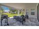 Inviting covered patio with comfortable seating overlooking a manicured lawn at 34516 Heavenly Ln, Dade City, FL 33525