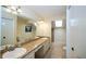Bathroom featuring double sinks, neutral tile, and a skylight at 34527 Cedarfield Dr, Dade City, FL 33523