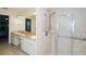 Bright bathroom featuring a double sink vanity and a glass-enclosed shower with grab bars at 34527 Cedarfield Dr, Dade City, FL 33523