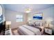 Bedroom featuring neutral decor, a ceiling fan, and a window with shutters at 34527 Cedarfield Dr, Dade City, FL 33523