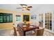 Traditional dining room featuring a wood table set for six, stylish light fixture, and decorative shutters at 34527 Cedarfield Dr, Dade City, FL 33523