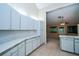 Bright kitchen with sleek white cabinets, laminate countertops, and ample storage space at 34527 Cedarfield Dr, Dade City, FL 33523