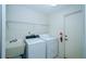 Functional laundry room with washer, dryer, and utility sink for added convenience at 34527 Cedarfield Dr, Dade City, FL 33523