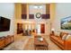 Inviting living room with high ceilings, stylish decor, and seamless flow to the dining area at 34527 Cedarfield Dr, Dade City, FL 33523