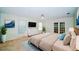 Cozy main bedroom featuring a plush bed, TV, and French doors leading to outdoor space at 34527 Cedarfield Dr, Dade City, FL 33523