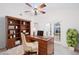 Bright office featuring a wooden desk, ample shelving, and french doors at 34527 Cedarfield Dr, Dade City, FL 33523