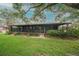 Charming screened porch extending from the house into the yard at 34527 Cedarfield Dr, Dade City, FL 33523