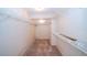 Walk-in closet with metal shelving and neutral carpet at 34527 Cedarfield Dr, Dade City, FL 33523