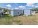 Backyard with an adjacent storage unit and storage shed at 37025 Lois Ave, Zephyrhills, FL 33542