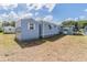 Exterior back view of a home with blue siding at 37025 Lois Ave, Zephyrhills, FL 33542