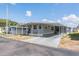 Charming single-story home featuring a covered parking area and a well-maintained yard at 37025 Lois Ave, Zephyrhills, FL 33542