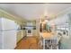 Charming kitchen features vintage cabinets, appliances, and a cozy dining area at 37025 Lois Ave, Zephyrhills, FL 33542