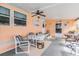 Enclosed lanai with ample seating, a ceiling fan, and outdoor views at 37025 Lois Ave, Zephyrhills, FL 33542