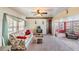 The living room offers carpet floors, lots of natural light, and easy access to other rooms at 37025 Lois Ave, Zephyrhills, FL 33542