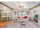 The living room has a ceiling fan, carpeted floors, and views of the dining area at 37025 Lois Ave, Zephyrhills, FL 33542
