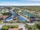 Aerial view of the community pool, tennis courts, and waterways near the homes at 3819 Barnegat Dr, Punta Gorda, FL 33950