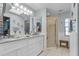 Bathroom featuring a double vanity, step-in shower, and bright natural light at 3819 Barnegat Dr, Punta Gorda, FL 33950