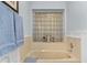 Soaking tub with unique privacy glass block window and neutral design at 3819 Barnegat Dr, Punta Gorda, FL 33950