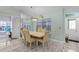 Bright dining area with a large window, stylish chairs, and elegant tile flooring at 3819 Barnegat Dr, Punta Gorda, FL 33950