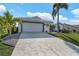 Charming single-story home with a two-car garage, a well-manicured lawn, and tropical landscaping at 3819 Barnegat Dr, Punta Gorda, FL 33950