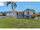 Attractive single-story home featuring a neatly kept lawn, decorative elements, and tropical landscaping at 3819 Barnegat Dr, Punta Gorda, FL 33950