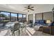 Enclosed sunroom featuring tile floors, ample seating, and picturesque canal views at 3819 Barnegat Dr, Punta Gorda, FL 33950